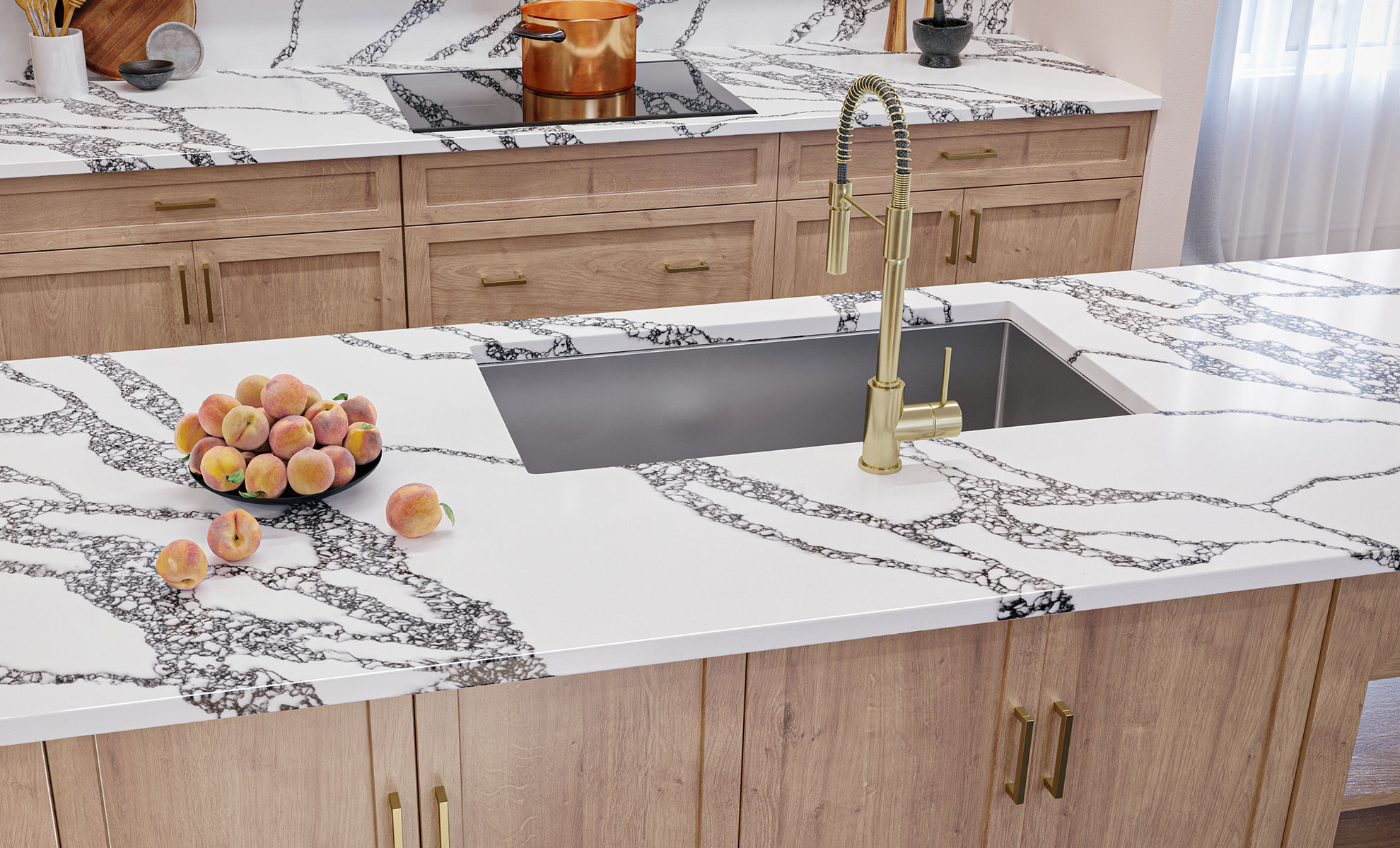 This image depicts a kitchen showcasing quartz countertops with bold veining and elegant gold hardware.