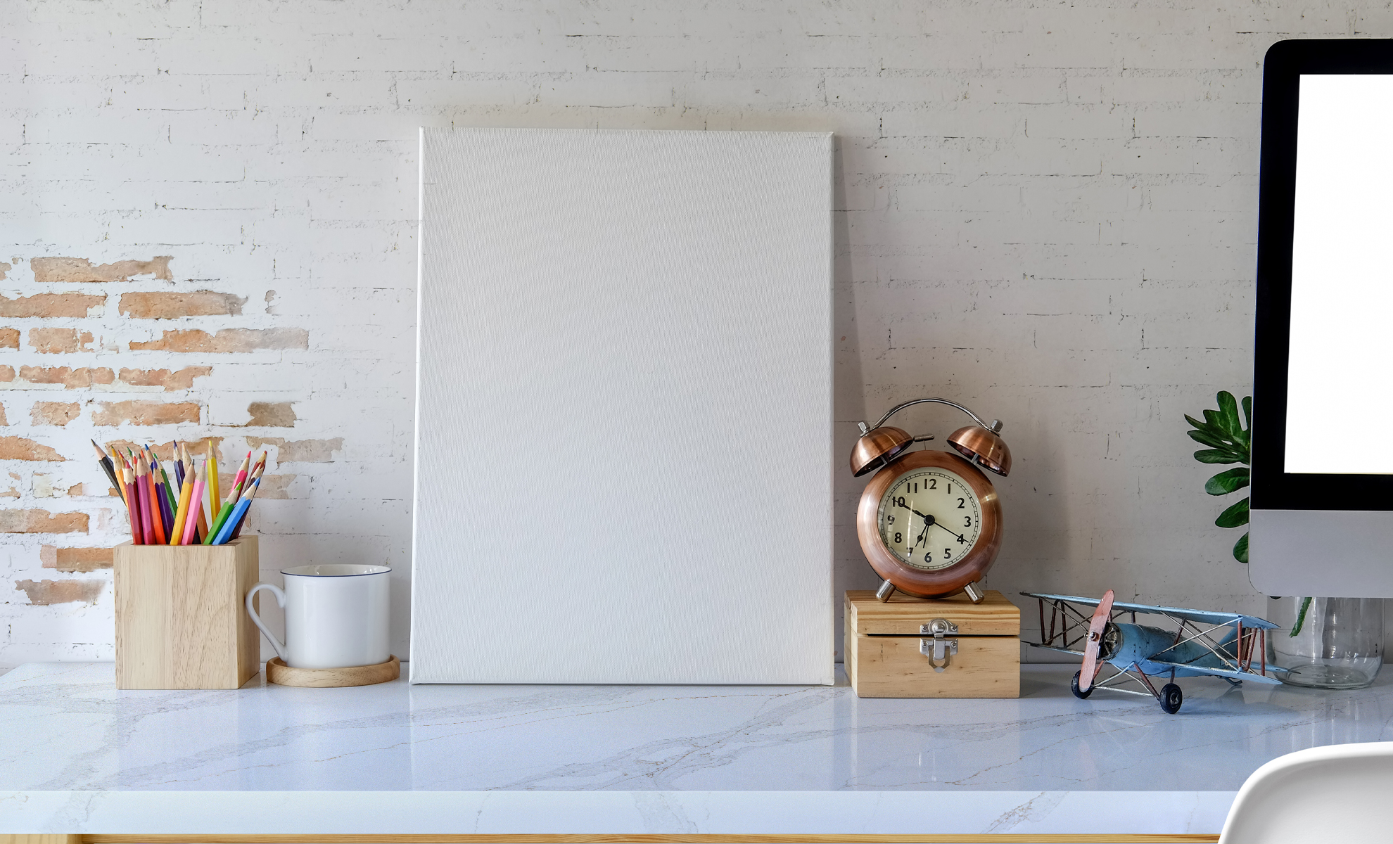 This image depicts a home office showcasing a quartz desktop with a complementing elegant exposed brick wall. 